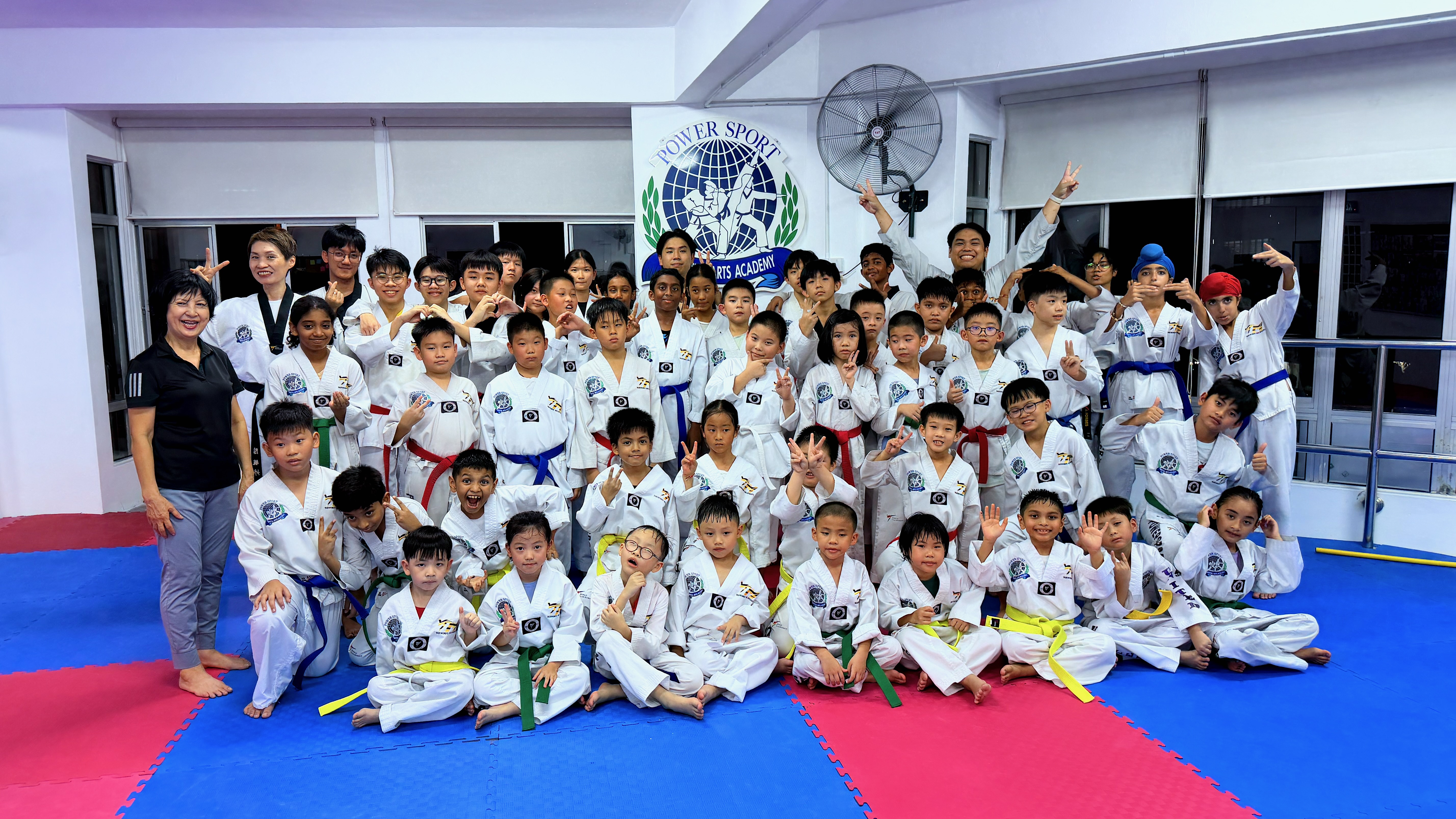 Power Sport students and instructors group photo on the training mats