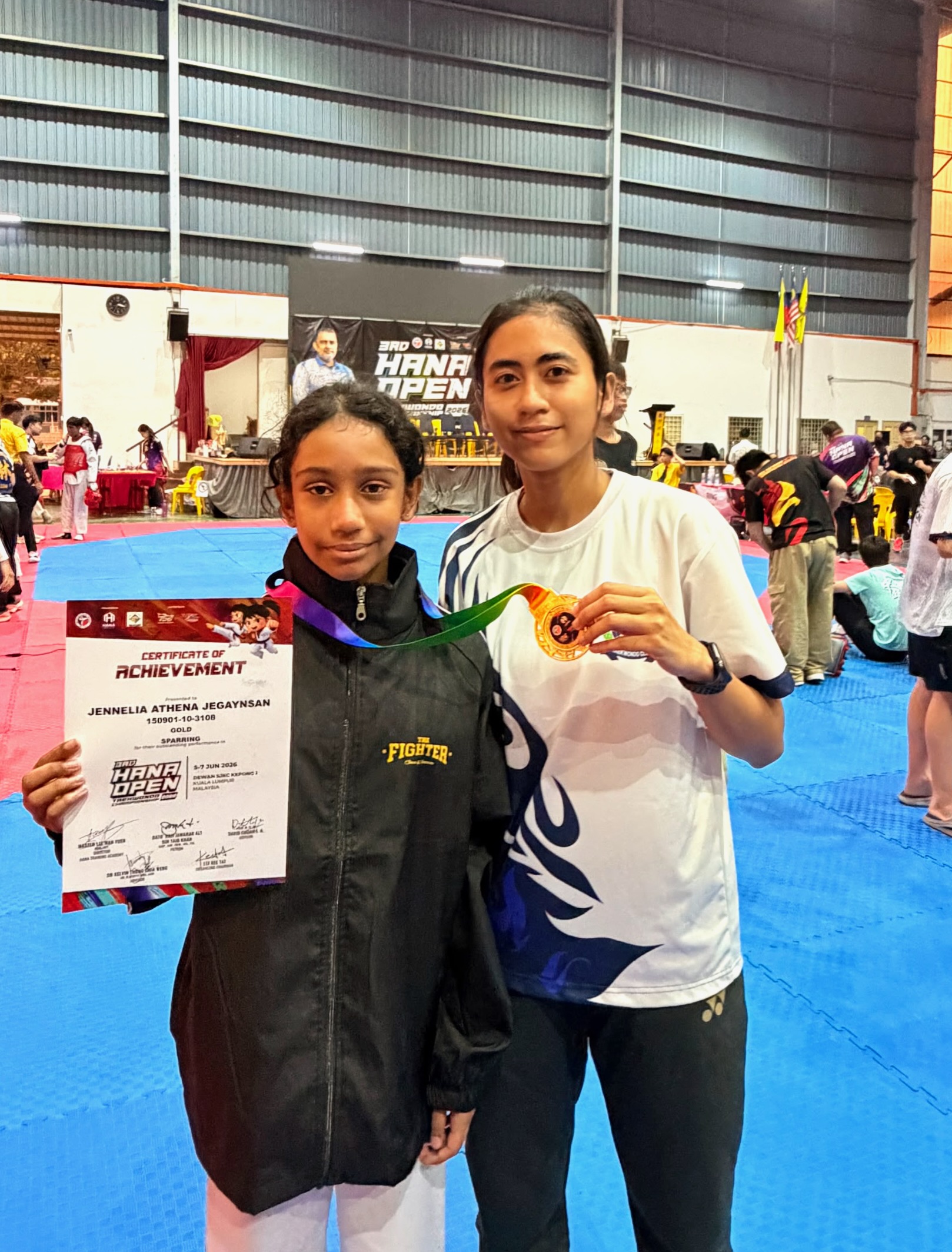Power Sport student and coach with a gold medal certificate