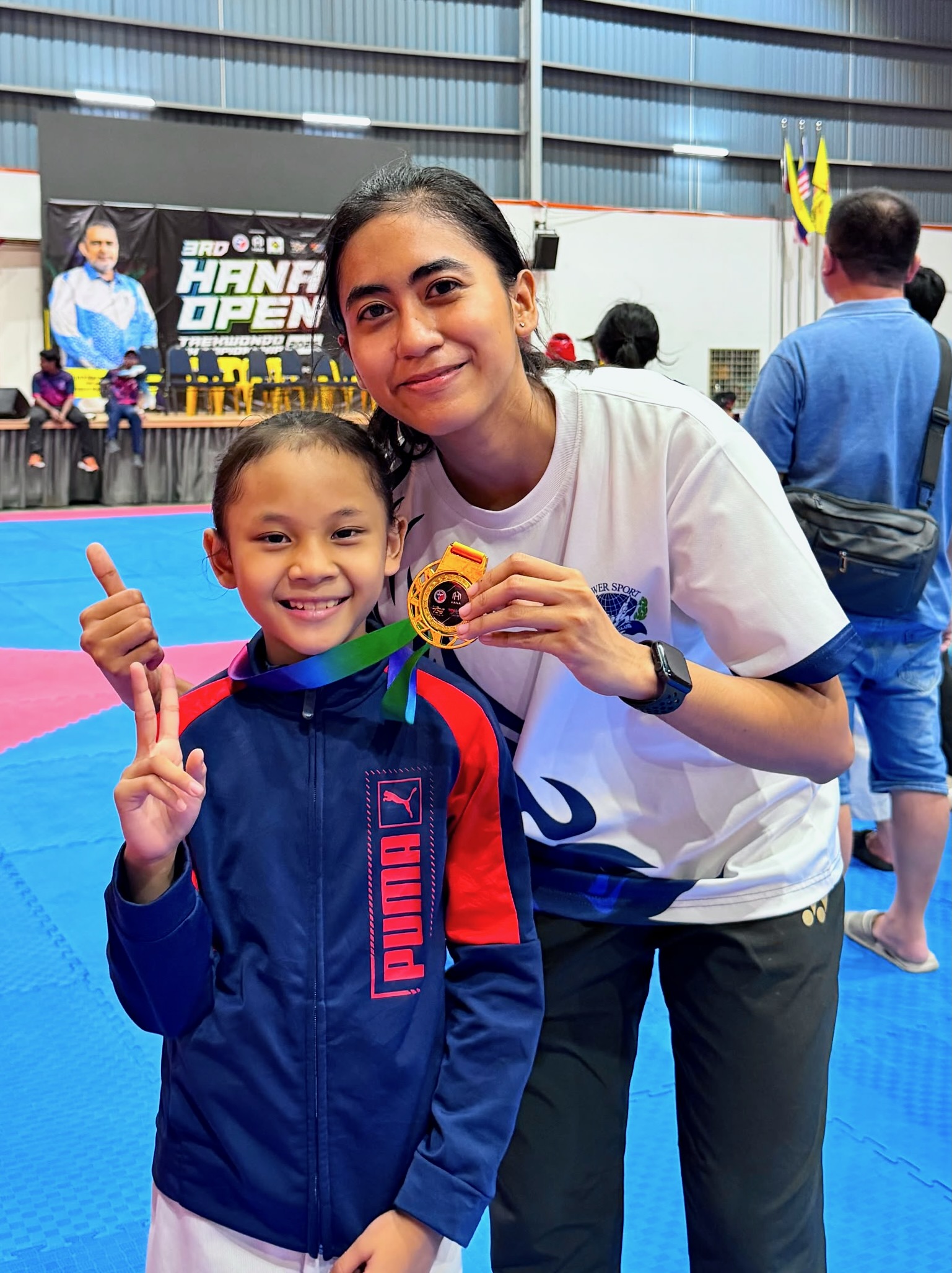Power Sport coach and student with a gold medal