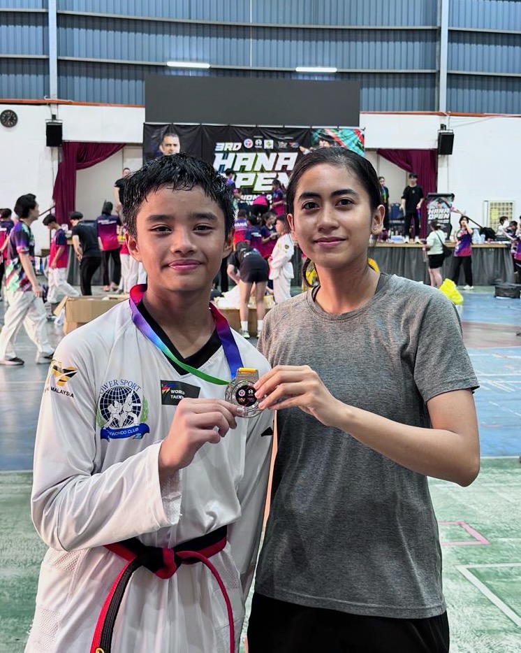 Power Sport student and coach with a medal