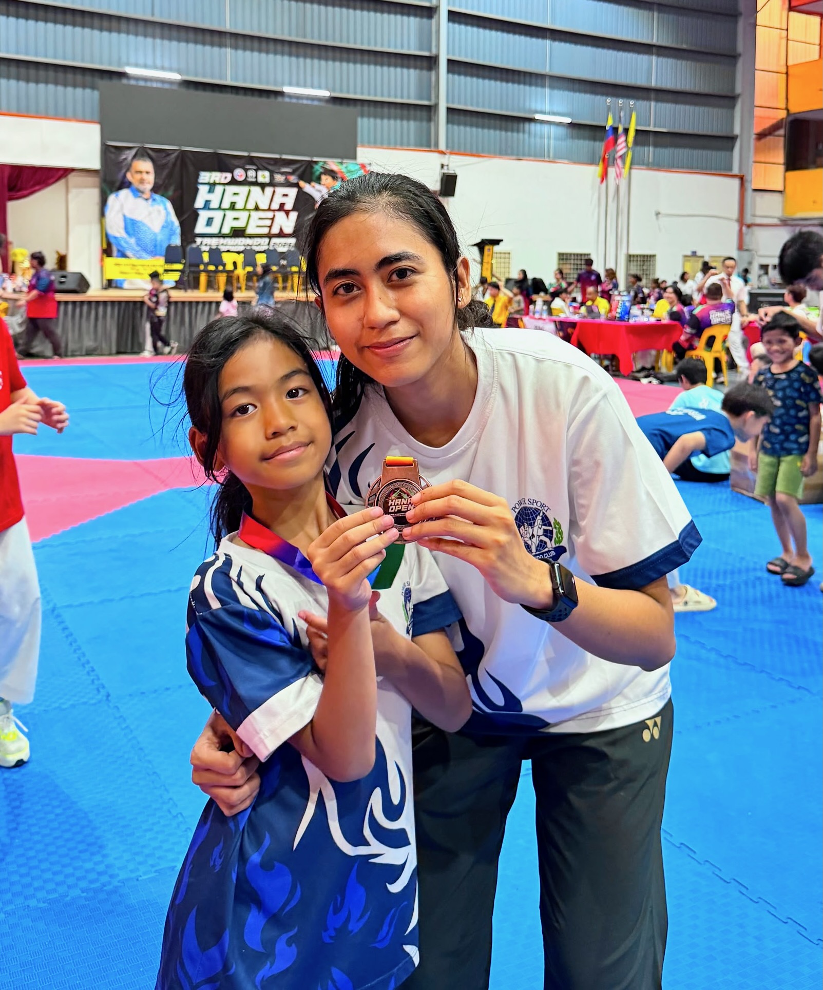 Power Sport coach and student with a medal