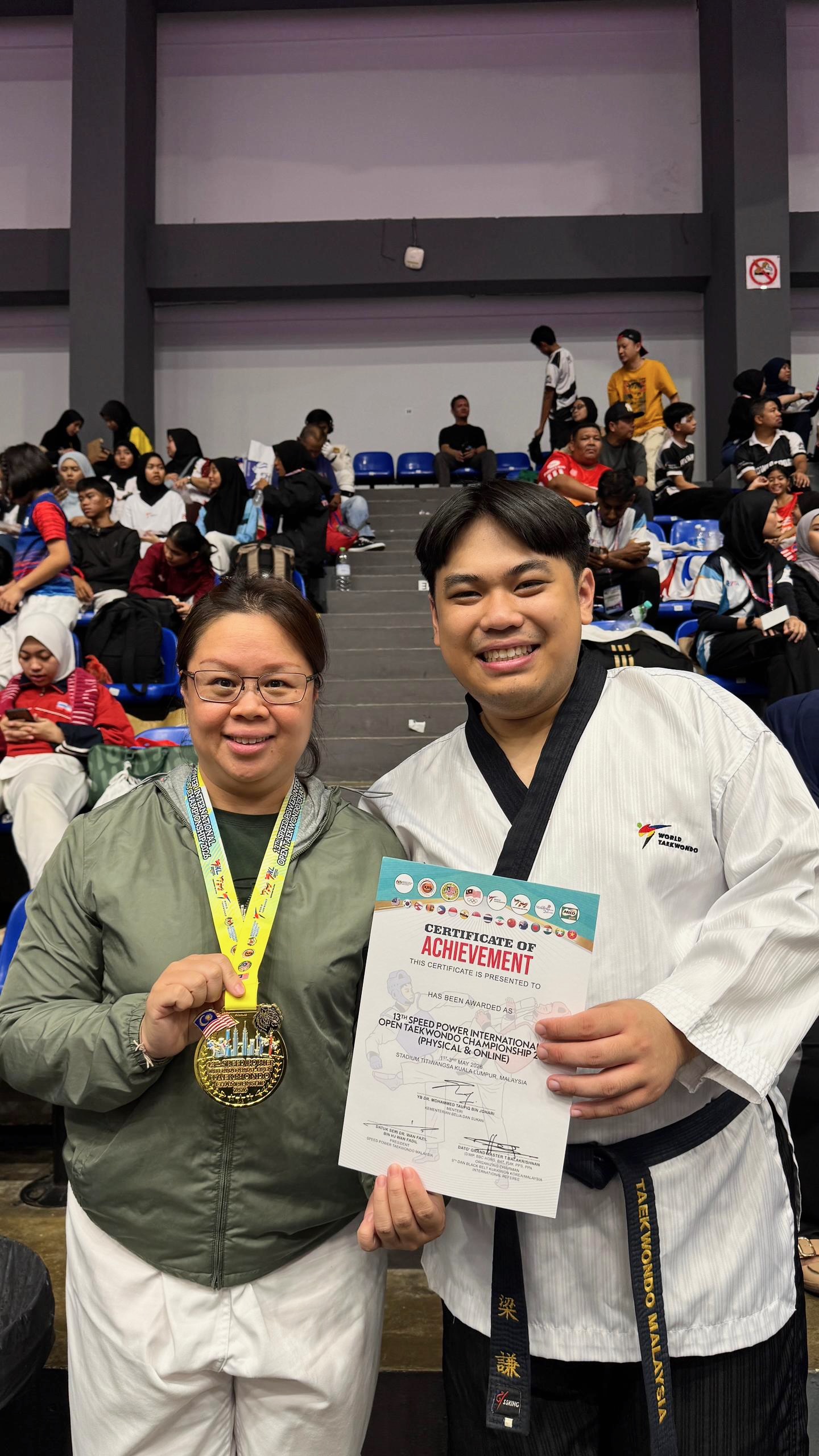 Power Sport coach and student with a gold medal certificate