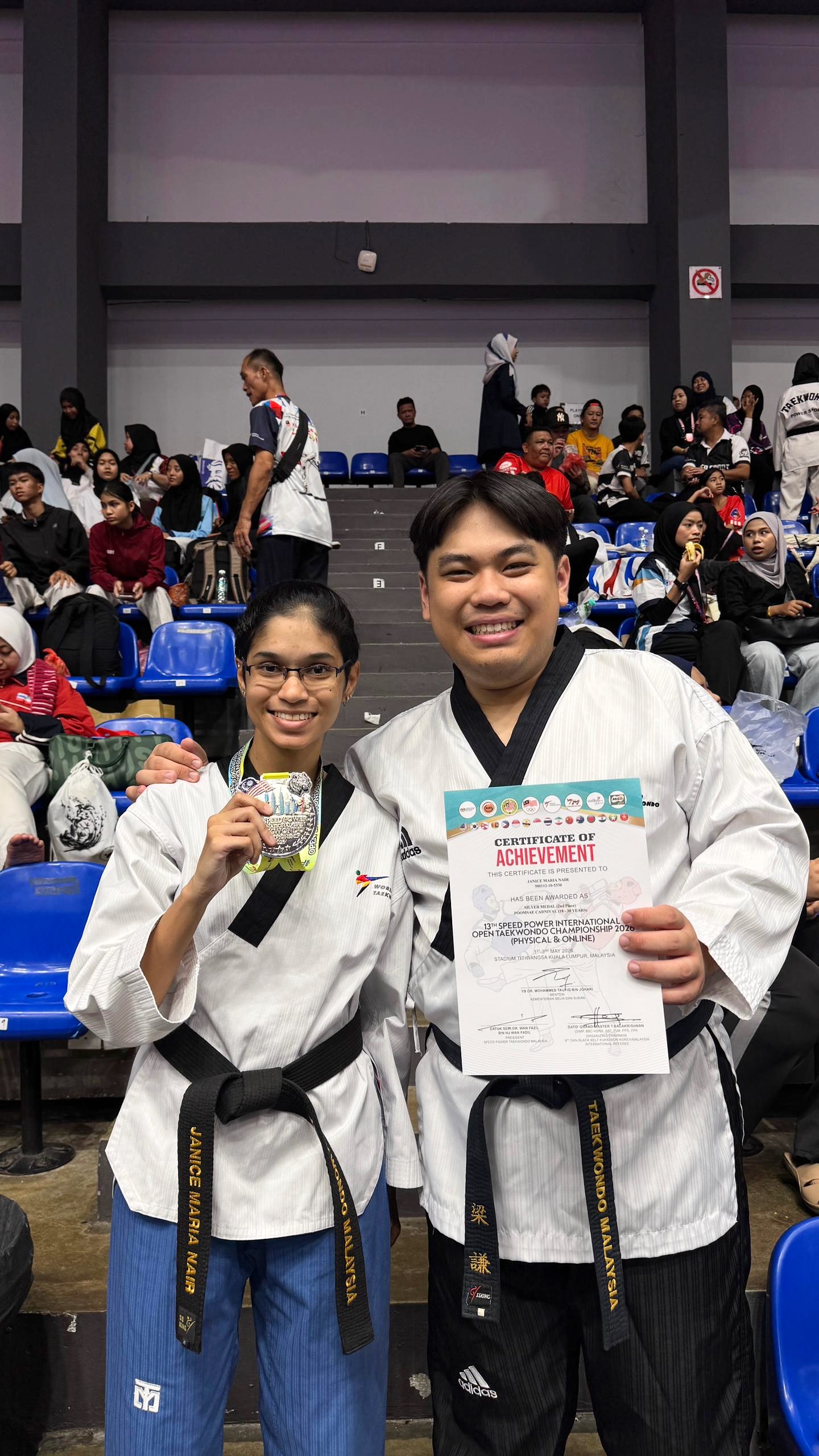 Power Sport coach and student with medal and certificate