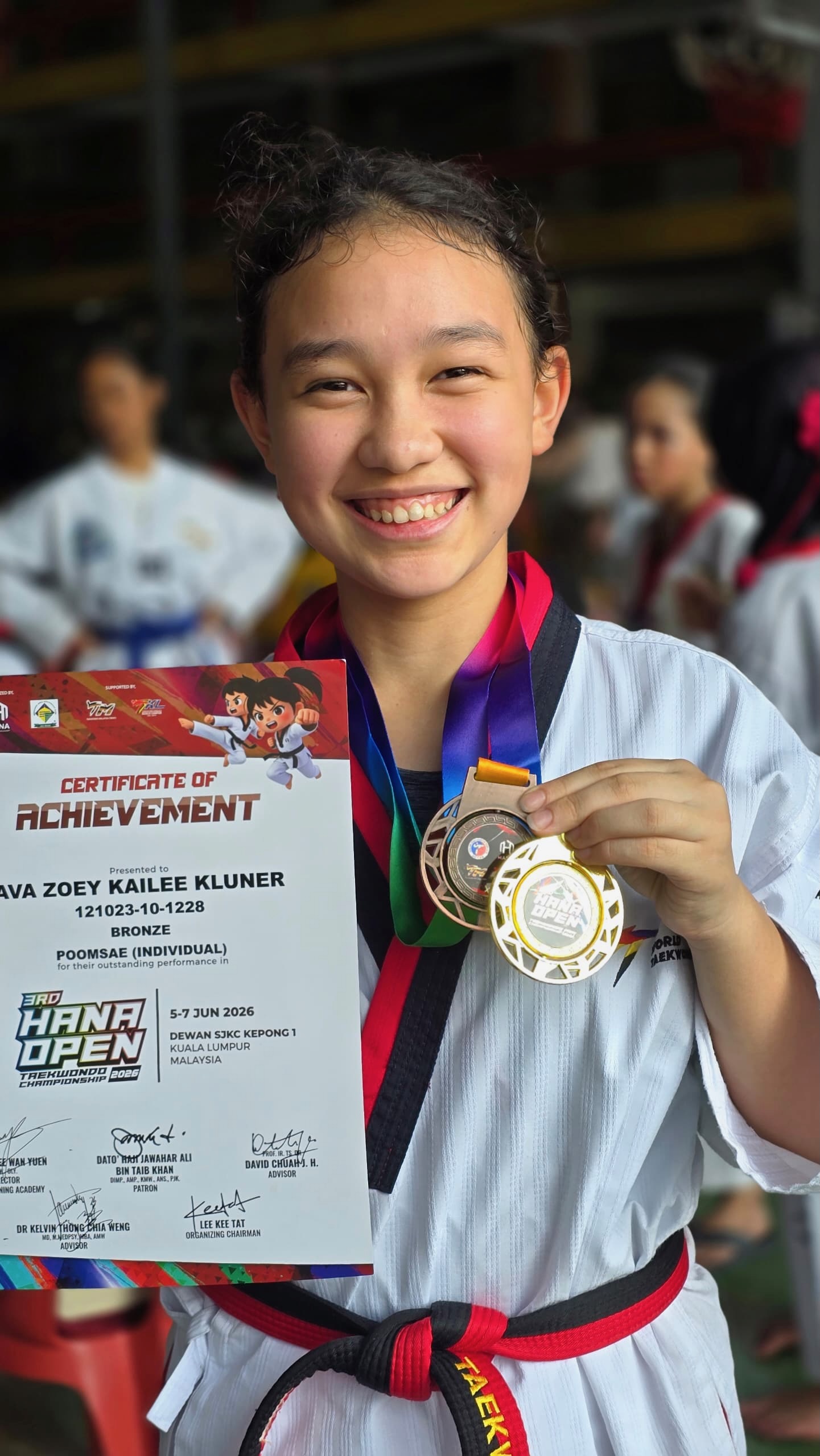Power Sport student with medals and a certificate