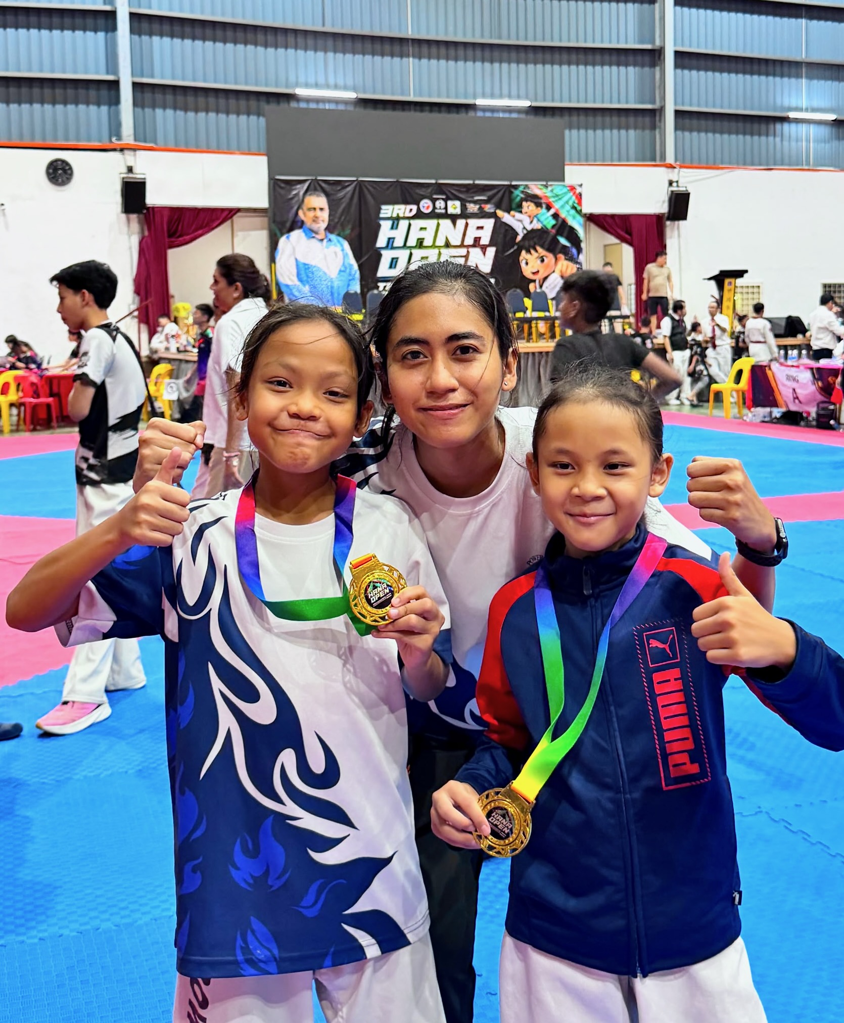 Power Sport students with a coach and gold medals